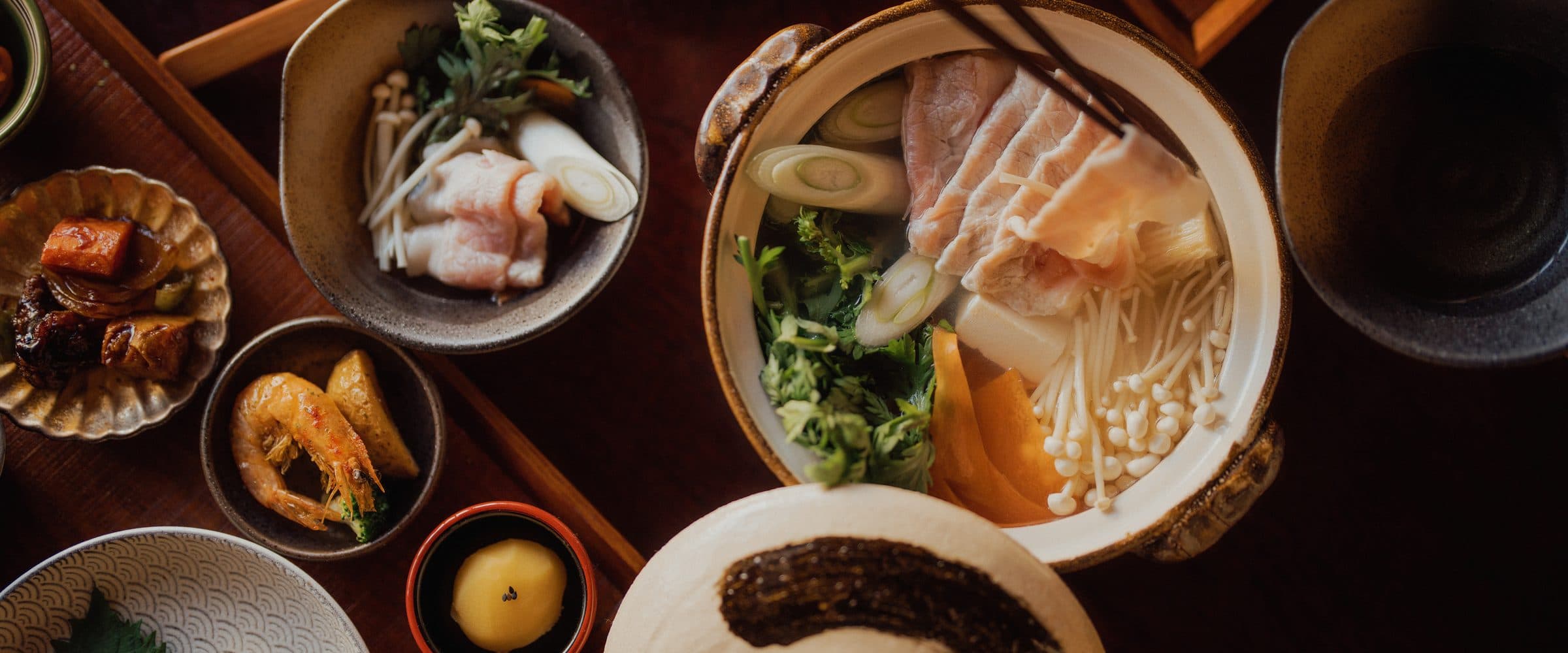 An overhead spread of donburi and izakaya dishes at Don Rice Bar in Henderson, NV